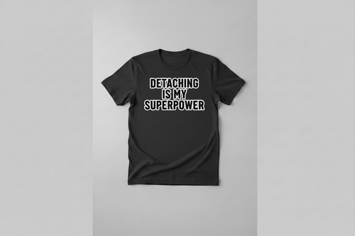Black t-shirt with 'Detaching is my superpower' text on a gray background